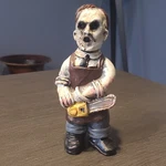 Hand Painted Matte Ceramic Lumberjack Boy Figurine W/ Chainsaw. 5" Tall.. Fixed Price $15.00.